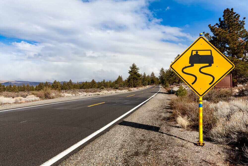 slippery when wet road sign